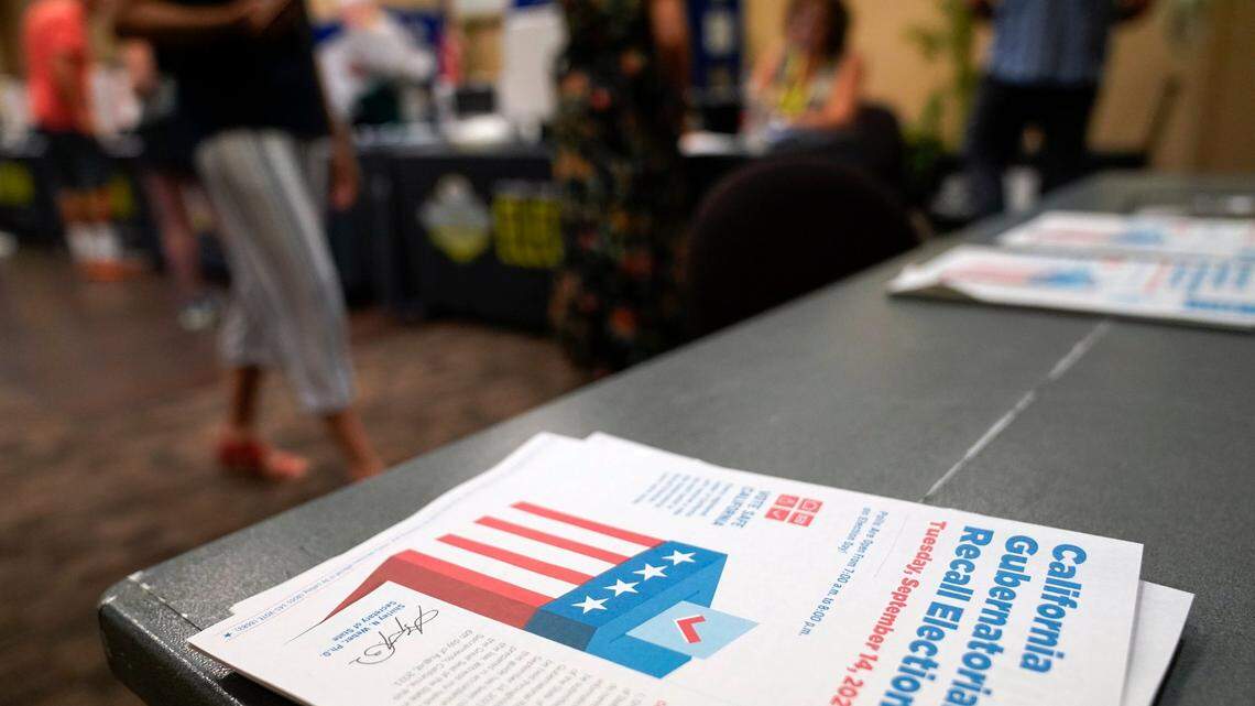 Voters’ guides lie on a table as people cast their ballots during the early voting period for the California gubernatorial recall election.