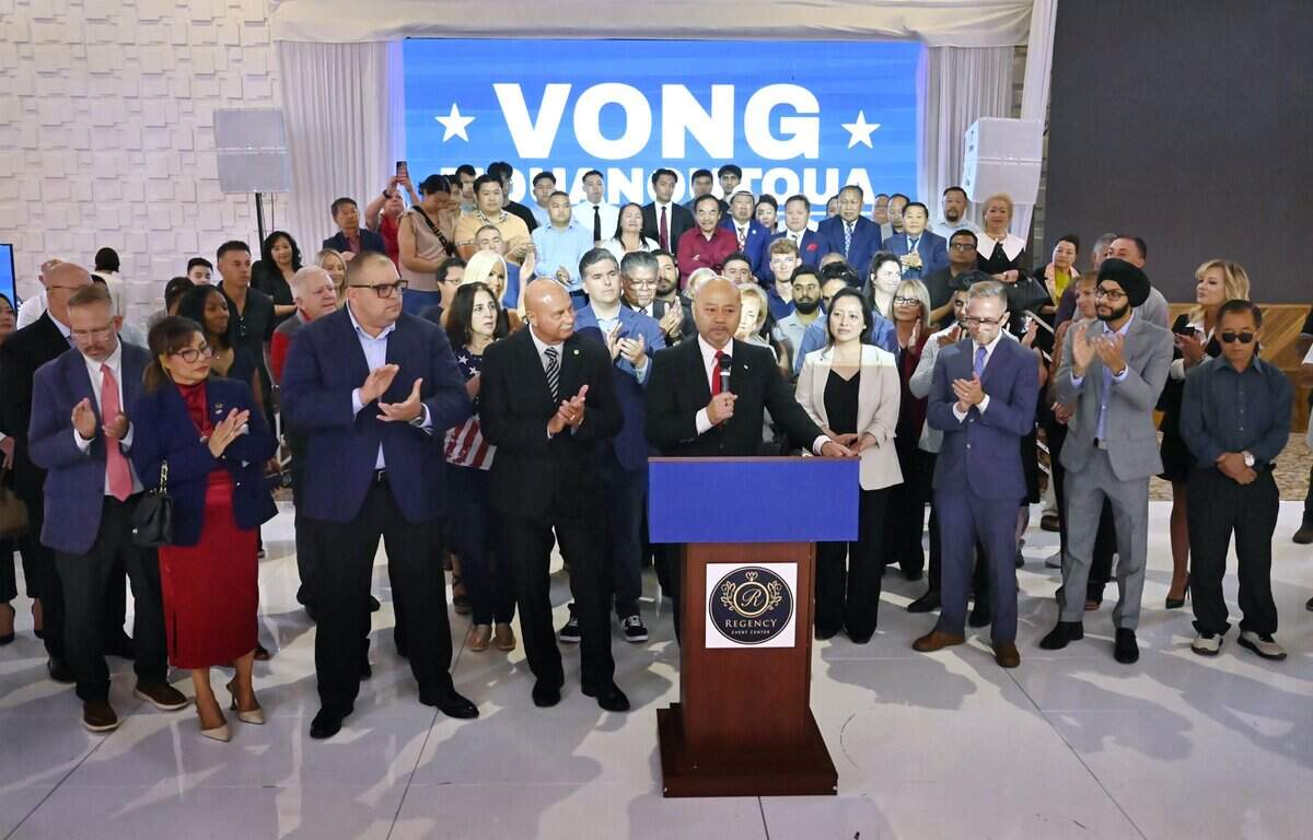 Clovis Mayor Vong Mouanoutoua, center, surrounded by applauding supporters, announces the launch of his campaign for Fresno County Board of Supervisors District 5 during an event at the Regency Event Center Friday, June 12, 2026 in Clovis.