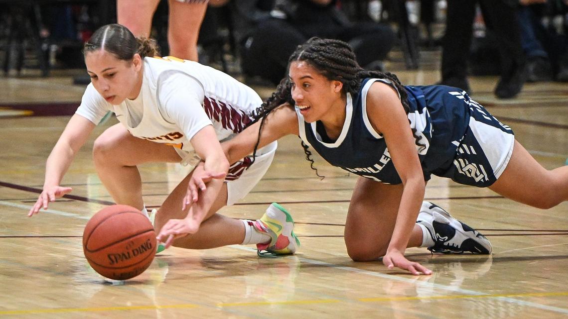 Clovis West’s Ariyah Smith, left, dives to try and steal the ball from Bakersfield’s Kyla Wandick during their Central Section Open Division championship game at Clovis West on Saturday, Feb. 26, 2022.