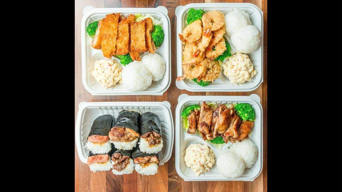 Ono Hawaiian BBQ sells plate lunches like these with white rice, macaroni salad and a choice of protein, like chicken or shrimp. Spam musubi, and other types of musubi (rice and meat wrapped in seaweed) are pictured on the lower left.