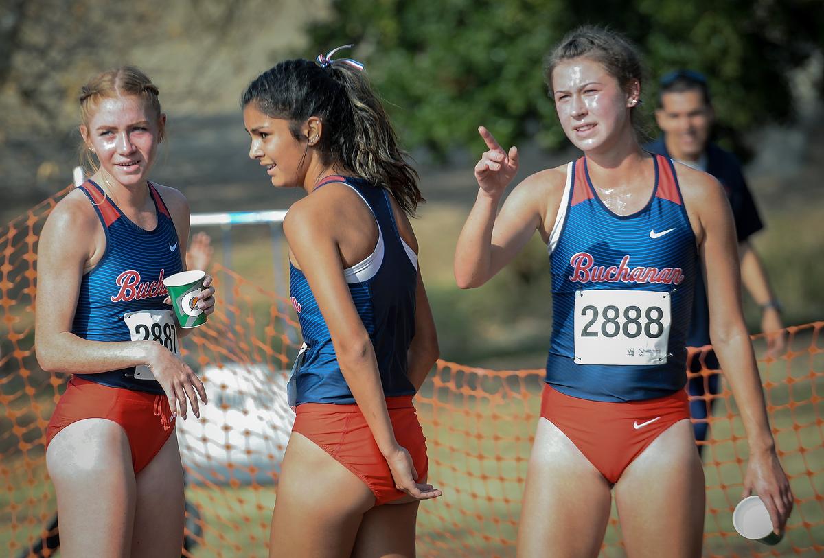 Buchanan’s Meagen Lowe, from left, Kaylee Elliott and Corie Smith wait at the finish as other teammates cross the line in the Central Section girls Division I cross country championships at Woodward Park on Thursday, Nov. 15, 2018. Smith finished first, Lowe was second and Elliott was fifth.
