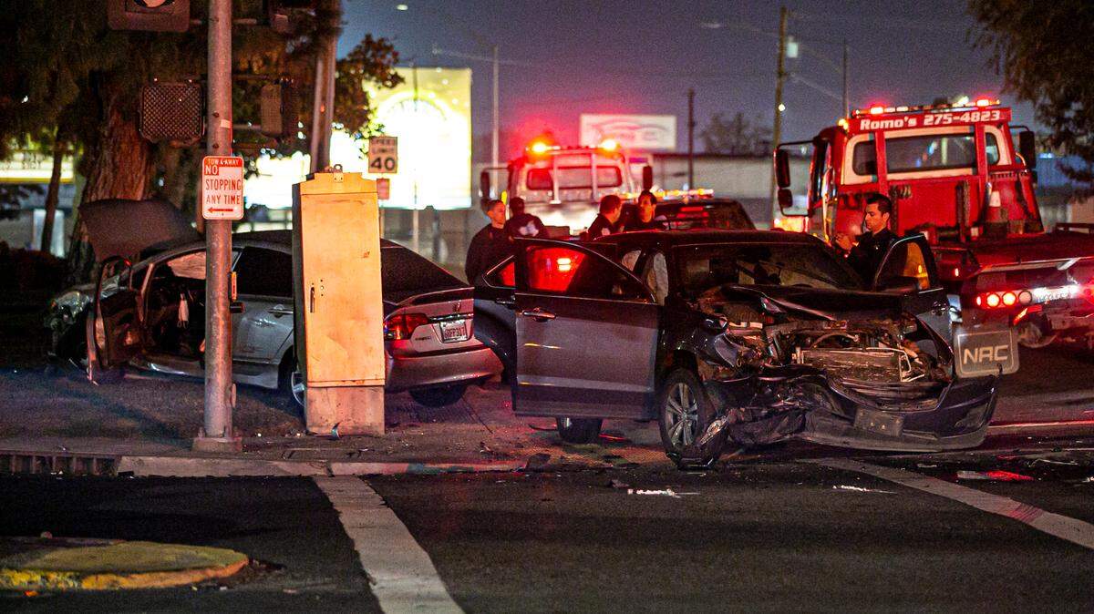 Officers investigate a crash involving a DUI driver at the intersection of Abby Street and Olive Avenue in central Fresno on Thursday, Nov. 25, 2021.