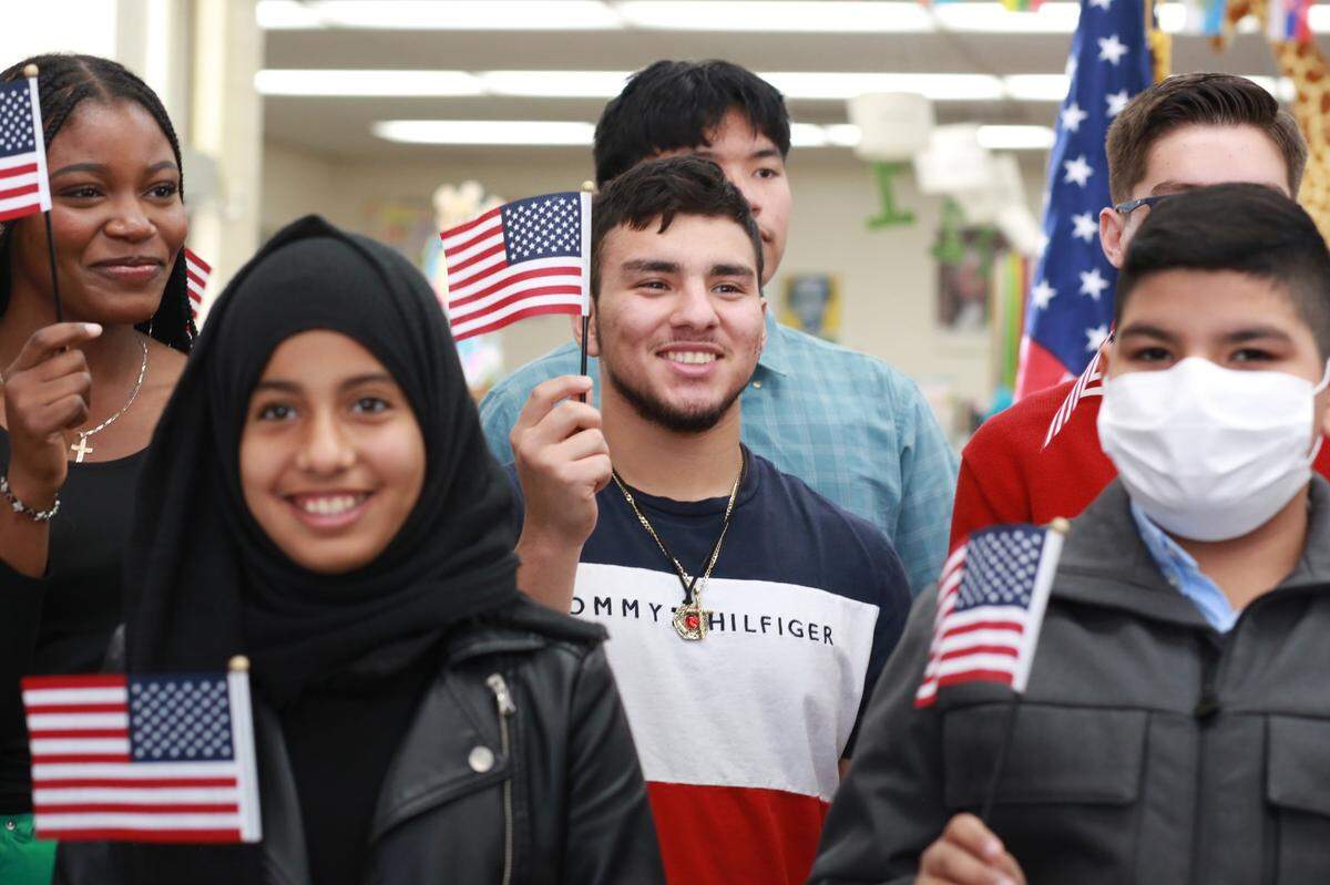 Among the newest citizens is 17-year-old Mauricio Gabriel Gómez Zabala, of Lamont, center, during the U.S. Citizenship and Immigration Services (USCIS) Special Children’s Ceremony Thursday afternoon at the Delano Branch Library.