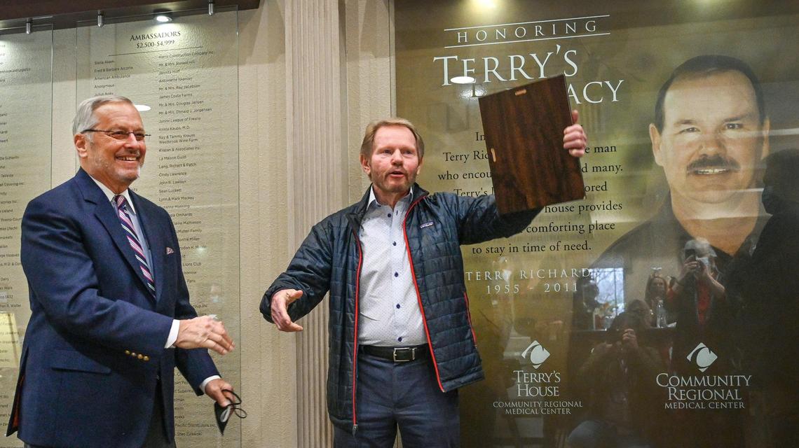 Fresno developer Tom Wheeler, center, accepts his recognition as the Fresno Chamber of Commerce’s 2022 Leon S. Peters Award recipient, after being introduced by former recipient Robert Oliver, left, a retired Fresno County Superior Court Judge, at Terry’s House in downtown Fresno on Monday, Dec. 20, 2021.