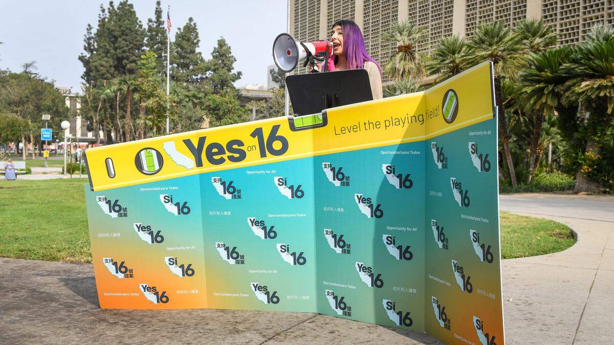 Fresno State student Josie Dominguez uses a bullhorn to talk to supporters about supporting Proposition 16 on the November ballot in front of the Fresno County Courthouse on Thursday, Oct. 8, 2020. Proponents of the measure sought to end the ban on affirmative action in state decision-making.