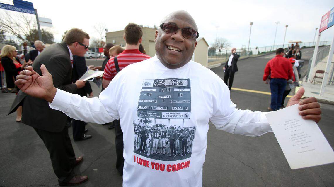 Former Fresno State football player Vince Wesson displays a shirt with the words “I Love You Coach” printed on it, at a memorial service for coach Jim Sweeney at Bulldog Stadium Saturday, February 16, 2013. Wesson died Saturday, Aug. 22, 2020.