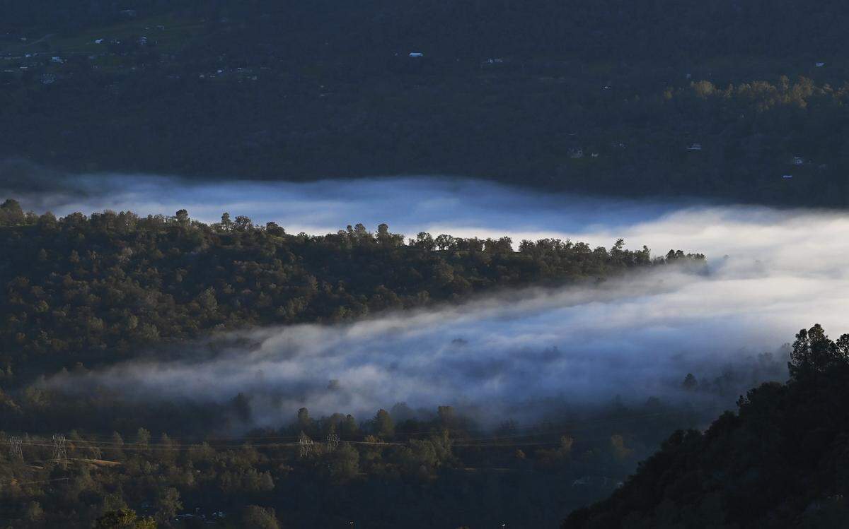 Fog drifts into the foothills as the Valley is covered by a thick blanket of cloud, seen from the 168 “four lane” around the 4,000 foot elevation Thursday afternoon, Dec. 11, 2025 near Prather.