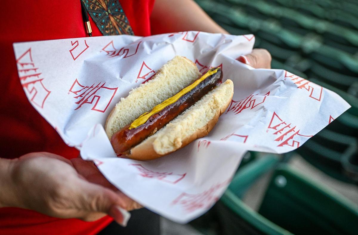 A fan gets ready to enjoy a hotdog at a Fresno Grizzlies game at Chukchansi Park in downtown Fresno on Wednesday, June 11, 2025.