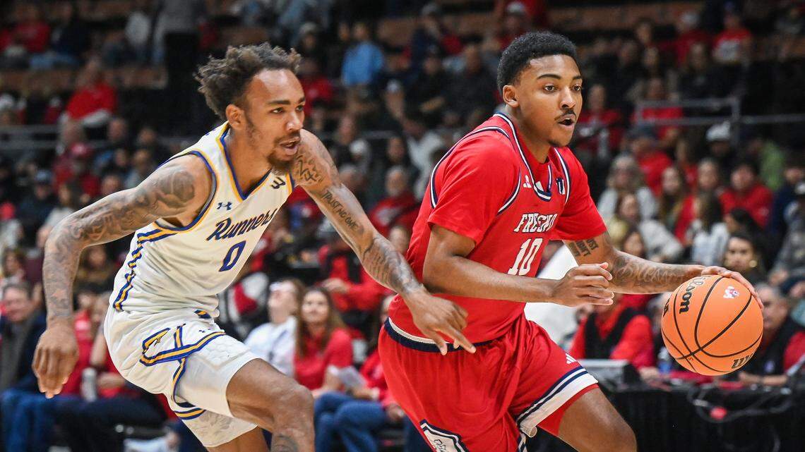 Fresno State's Zaon Collins, right, drives against CSU Bakersfield's CJ Hardy during their non-conference game at Selland Arena in downtown Fresno for the “Return to Selland” game on Sunday, Nov. 30, 2025. 