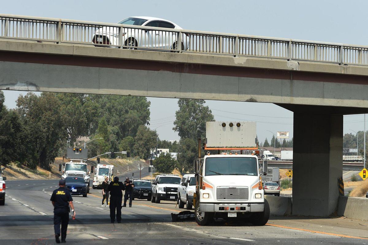 A Caltrans attenuator truck-carrying a “lane closed” warning sits Saturday morning, Aug. 14, 2021, during the investigation of a fatal accident in which it was struck from behind on Highway 99 at Ashlan Avenue by a small sedan whose driver later died.