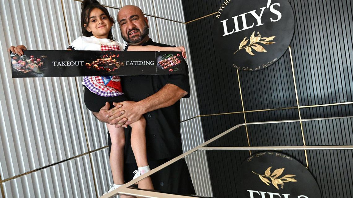 Gevork “George” Mkrtchyan holds his daughter Lily, 6, at the new Mediterranean take-out restaurant Lily’s Kitchen & Catering, which he and his wife Sara Sulukyan opened in September this year. Lily’s is located at Bullard and West avenues.
