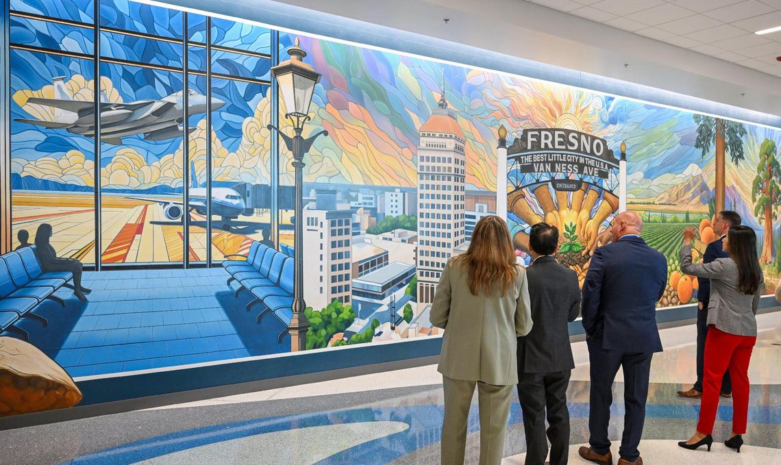 Mayor Jerry Dyer, city council members and VIPs check out the new mural created by South Valley artists Colleen Mitchell-Veyna and Kelsey Gilles that adorns a large wall near the expanded security checkpoint at Fresno Yosemite International Airport on Wednesday, April 23, 2025.