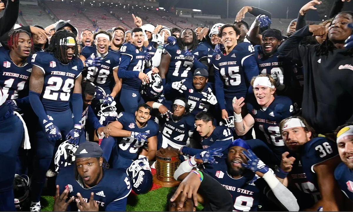 The Fresno State football team gathers for photos as it celebrates its 32-28 win over San Diego State, pulling ahead in the final minutes to win the Battle For The Old Oil Can Saturday, Oct. 29, 2022 in Fresno.