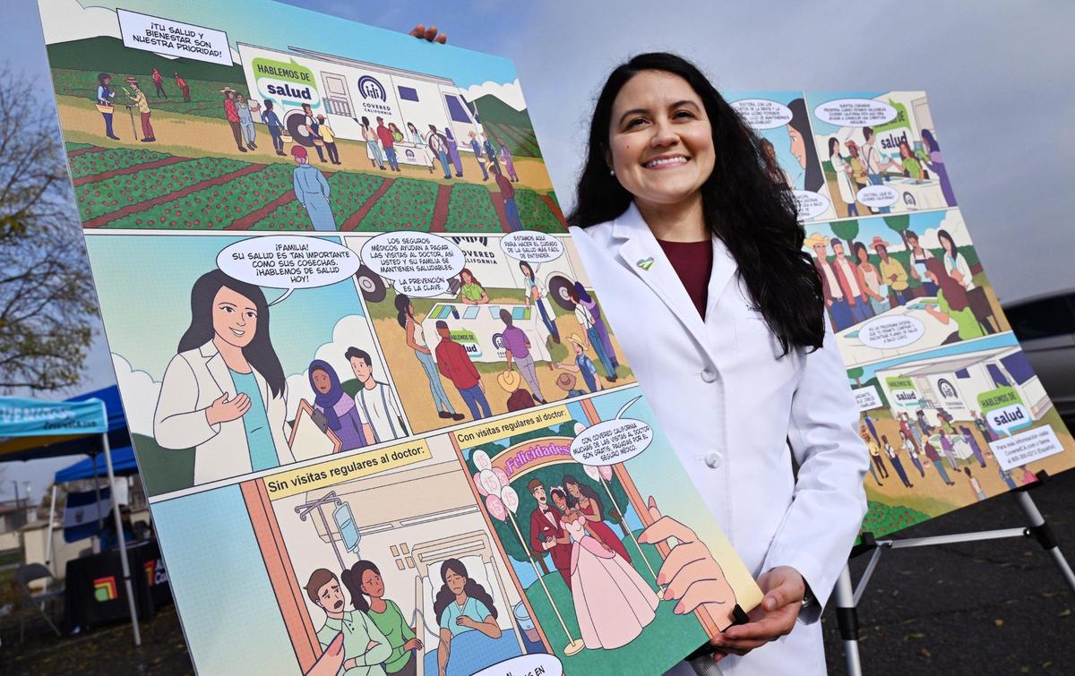 Dr. Trinidad Solis with Fresno County Public Health displays the new comic book with a representation of herself, seen to the left. The free comic book, available in Spanish and English, was handed out for free during a Covered California event held in Mendota Thursday, Dec. 12, 2024 and advocates the need for health insurance and healthcare for the farmworker community.