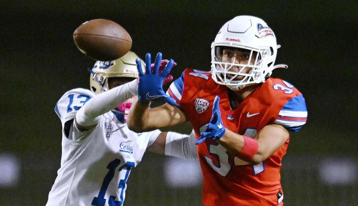 Buchanan’s Logan Tyler Phillips, right, makes the catch covered by Clovis High’s Ayden Hernandez, left, Friday, Oct. 4, 2024 in Clovis. Clovis led Buchanan 14-3 at haltime.
