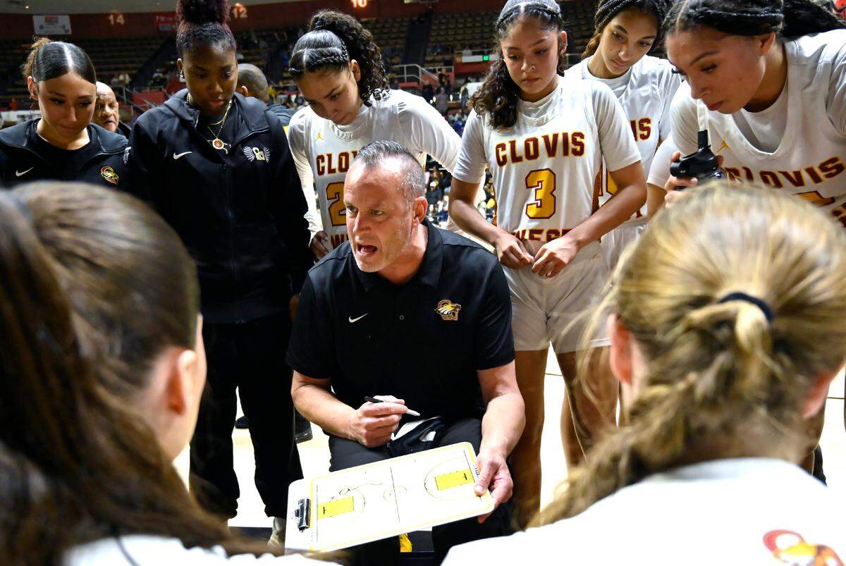 Clovis West head coach Craig Campbell, center, talks to the team between periods in the CIF Division I Girls Basketball Championship Saturday, March 1, 2025 in Fresno.