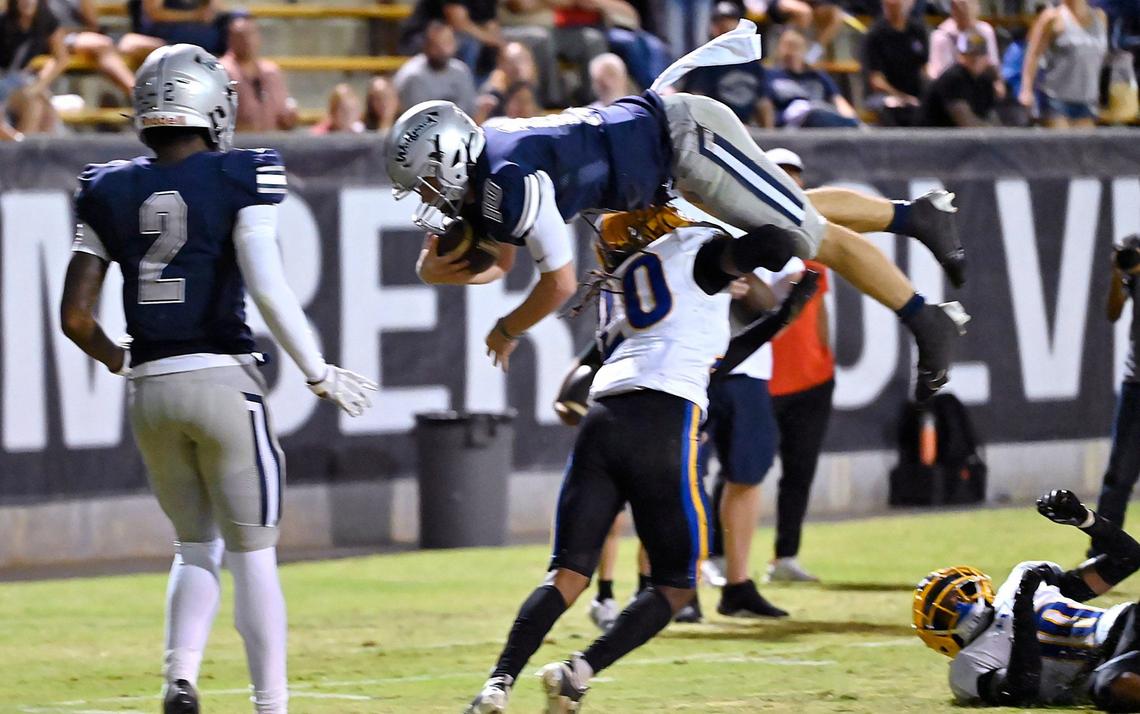 Grant Union’s Ezekiel Castex, bottom, stops Clovis East quarterback Tyus Miller, top, near the goal line Friday, Sept. 13, 2024 in Clovis.