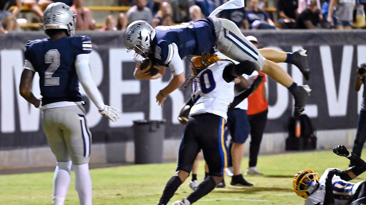 Grant Union’s Ezekiel Castex, bottom, stops Clovis East quarterback Tyus Miller, top, near the goal line Friday, Sept. 13, 2024 in Clovis.