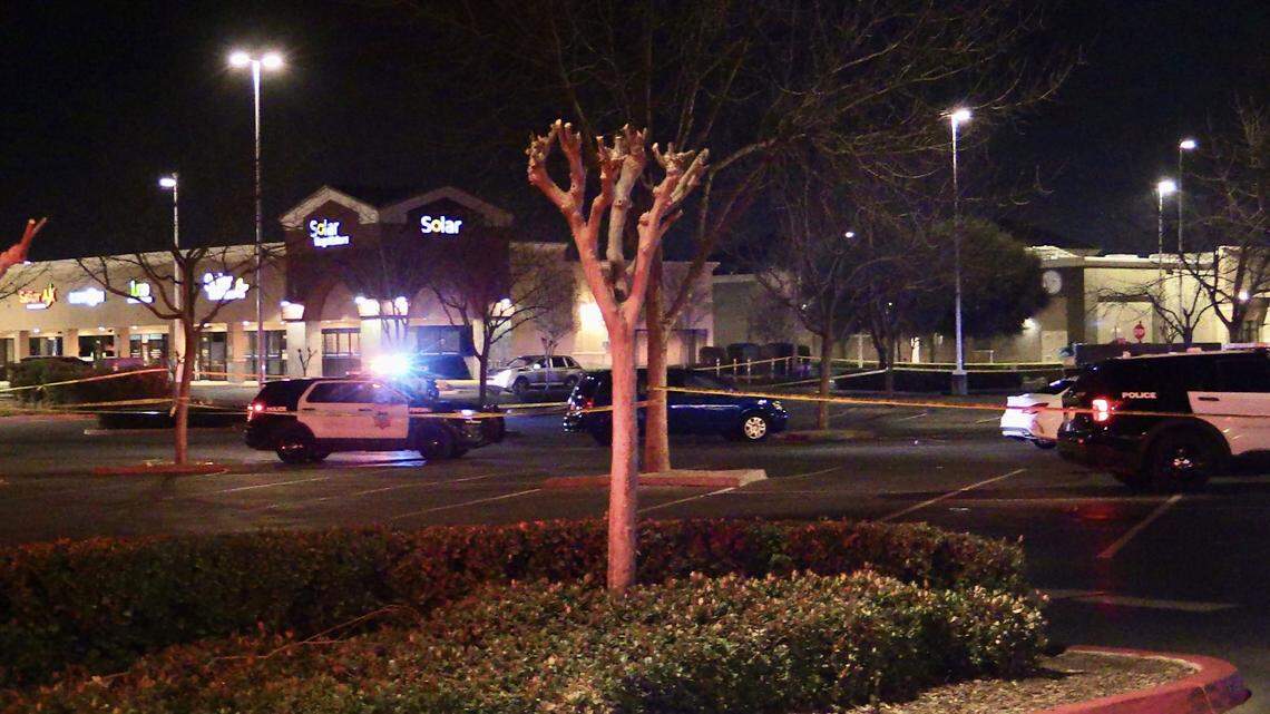 Police tape up the parking lot at Herndon Place at Milburn Avenue after one person was shot and killed and and another critically injured on Sunday, Feb. 19, 2023. The second person later died at a local hospital, police said.