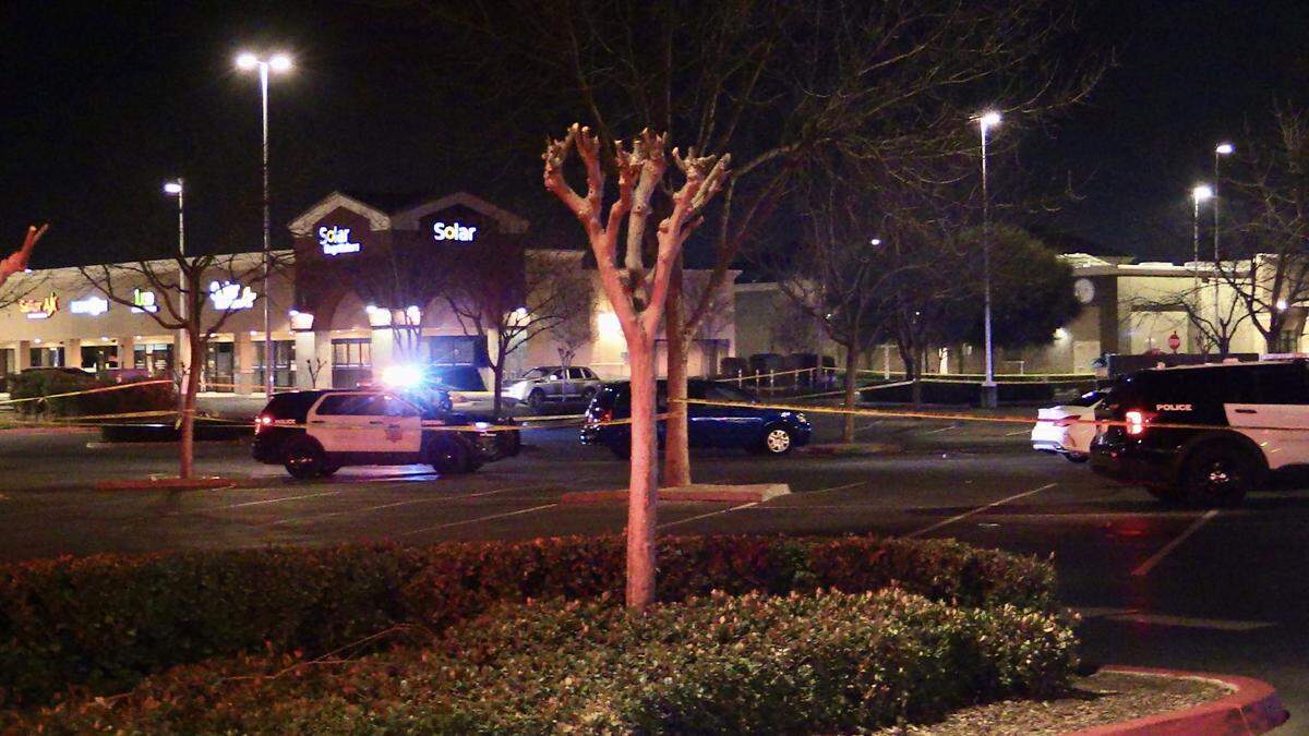 Police tape up the parking lot at Herndon Place at Milburn Avenue after one person was shot and killed and and another critically injured on Sunday, Feb. 19, 2023.
