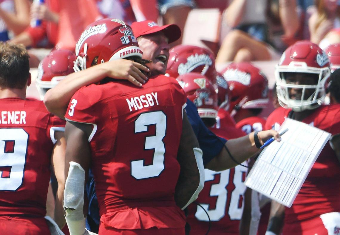Fresno State coach Kalen DeBoer, right, congratulates Arron Mosby following his touchdown on a sack, forced fumble and fumble recovery in a 45-0 victory over UConn Saturday, Aug. 28, 2021 in Fresno.