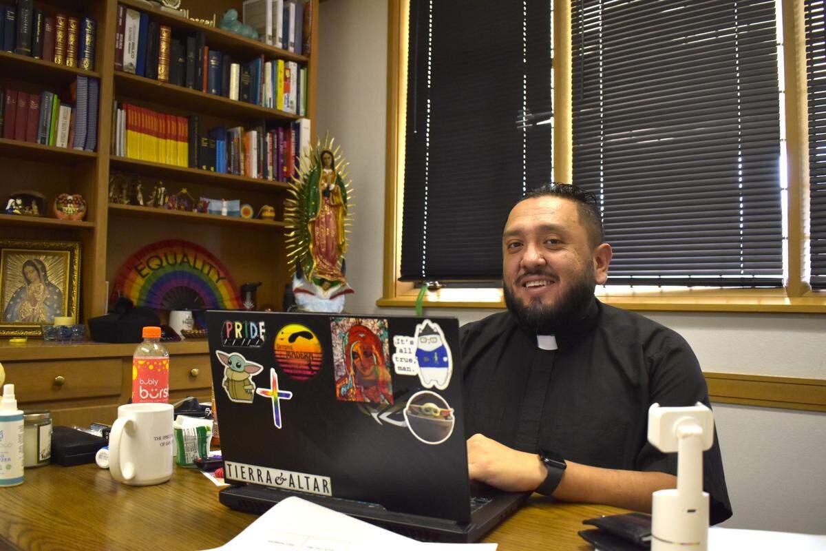Rev. Nelson Serrano Poveda, Latino/Hispanic missioner at Fresno’s St. James Episcopal Cathedral, poses for a photo in his office on Oct. 8, 2024. Poveda adorns his office with Christian figures made in different parts of the world.