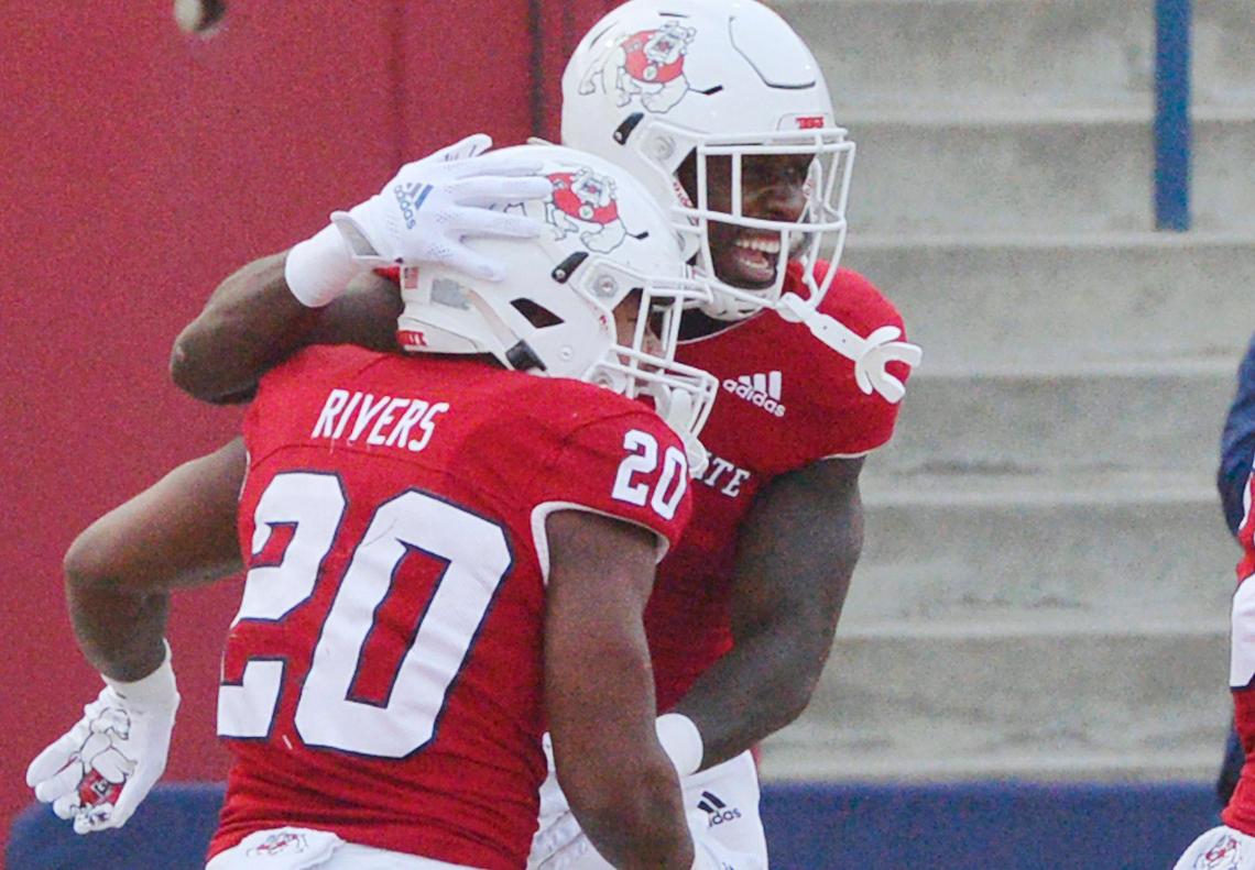 Fresno State running back Jordan Mims, right, celebrates Ronnie Rivers’ 50th career touchdown touchdown in the first quarter of the Bulldogs’ Mountain West game against New Mexico Saturday, Nov. 13, 2021 in Fresno. The Bulldogs led 24-0 at halftime.