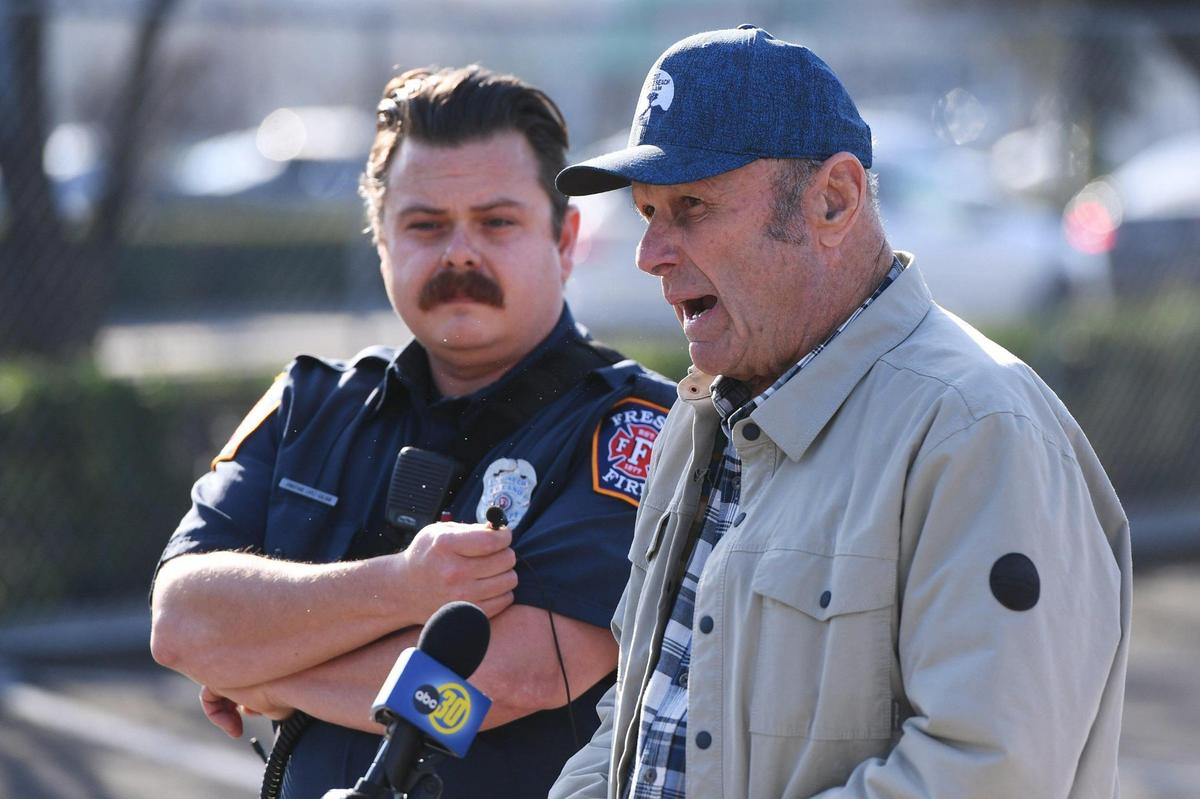 Valley Crime Stoppers President Dale Mendoza, right, with Fresno Fire public information officer Jonathan Lopez to the left, announces an increase of a reward to $5,000 for information about the fire that consumed several businesses in a strip mall near Kings Canyon and Clovis avenues during a press conference at the site Wednesday, Jan. 18, 2023 in Fresno.