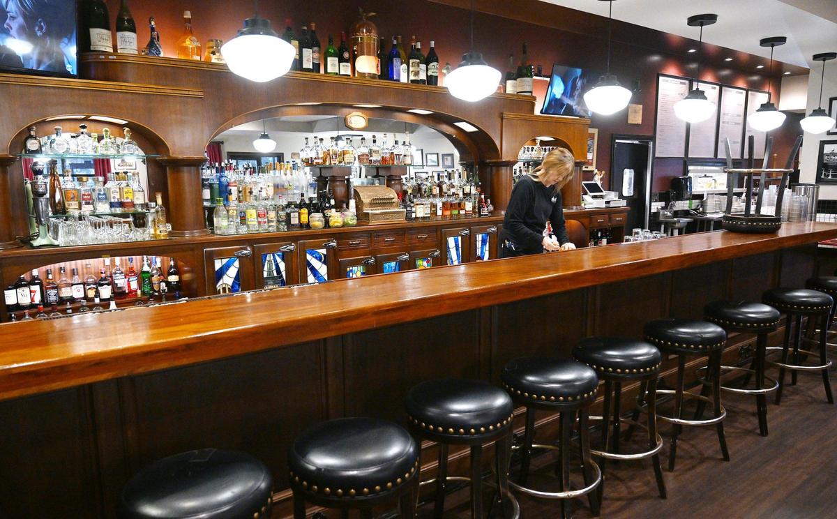 Stained glass cabinet doors can be seen behind the bar at Cosmopolitan Tavern & Italian Grill located in downtown Fresno. Photographed Friday, Oct. 25, 2024.