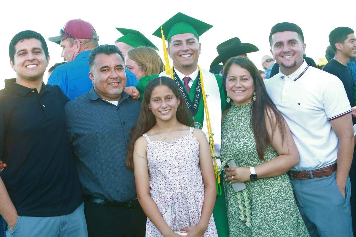 Riverdale High School salutatorians Iván Ibarra, with his family during the graduation ceremony Friday night (June 10) at Cowboys Stadium Jack King Field.
