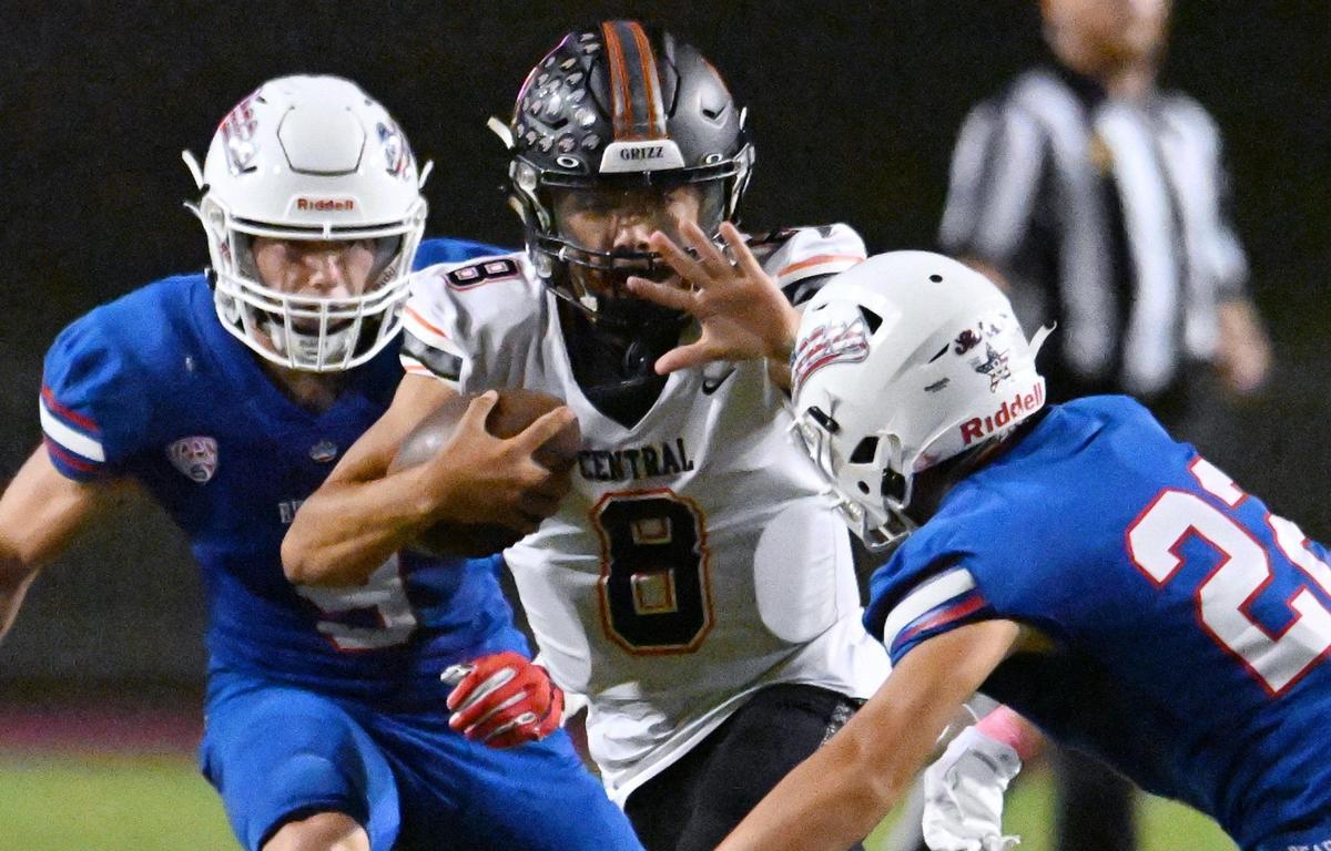 Central quarterback David Marquez is pursued by Buchanan’s Maddox Bracha, right, Thursday, Oct. 5, 2023, in Clovis. Central went on to win 27-6.