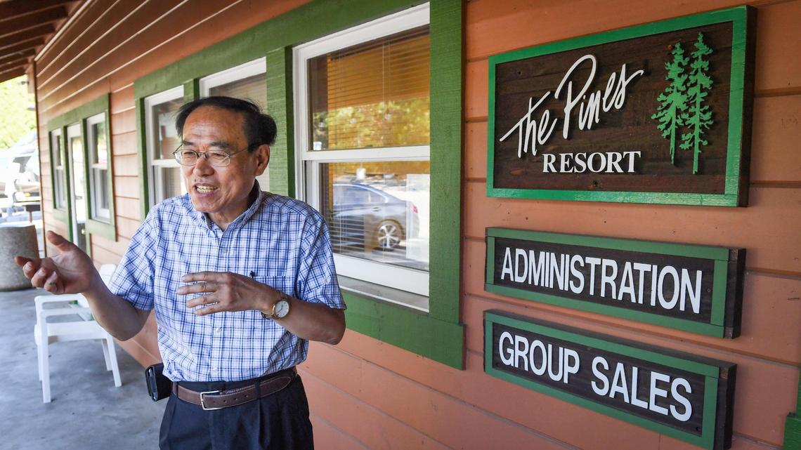 Kyusun Choe, owner of The Pines Resort, stands outside the administrative offices of the resort in Bass Lake on Monday, June 22, 2021.