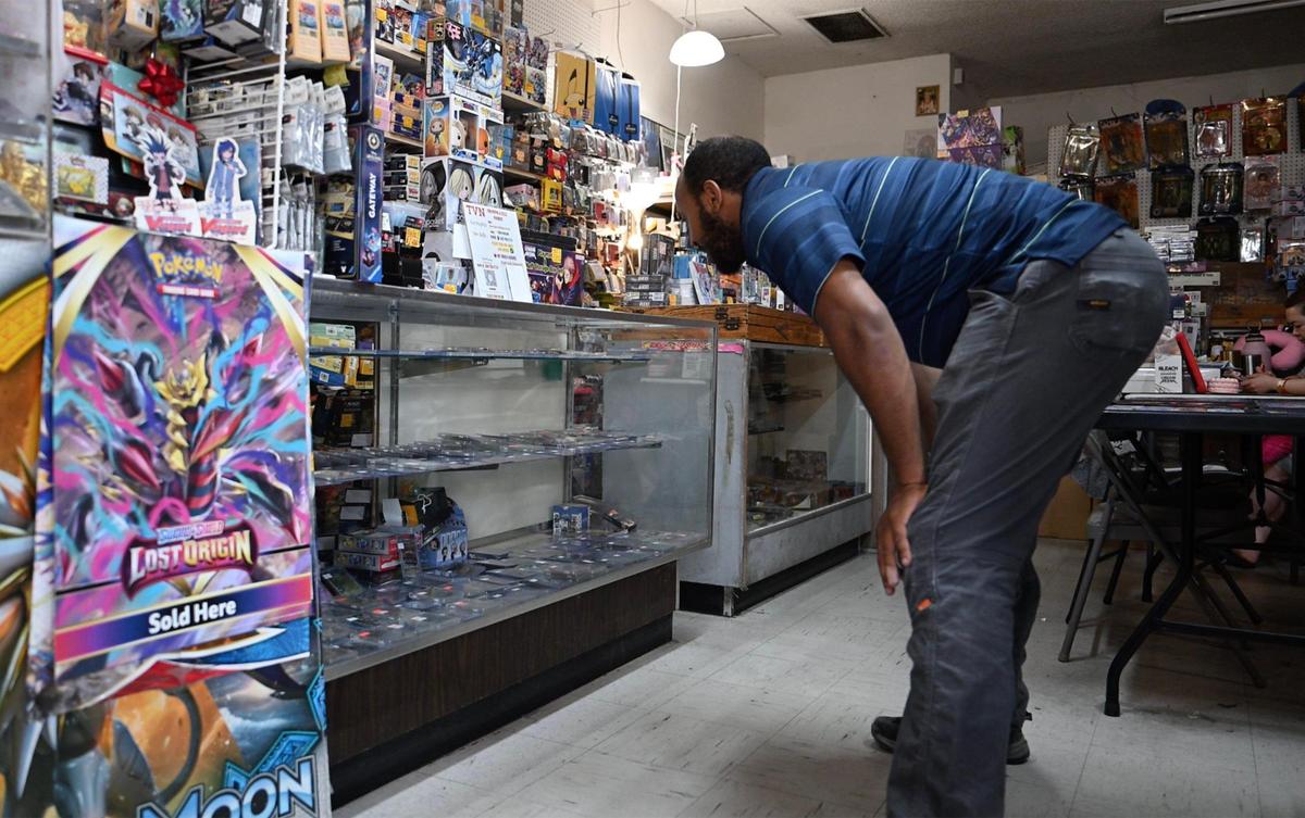 Fresno’s Ermiyas G takes a look at the collectibles in the case at TVN Sports Cards & Collectibles. TVN owner Thor Phoeung chose to offer seven copies of the limited edition Pokemon Prismatic Evolution Super Premium Collection Box through a lottery in hopes of not creating a craze. Photographed Friday, May 16, 2025 in Fresno.
