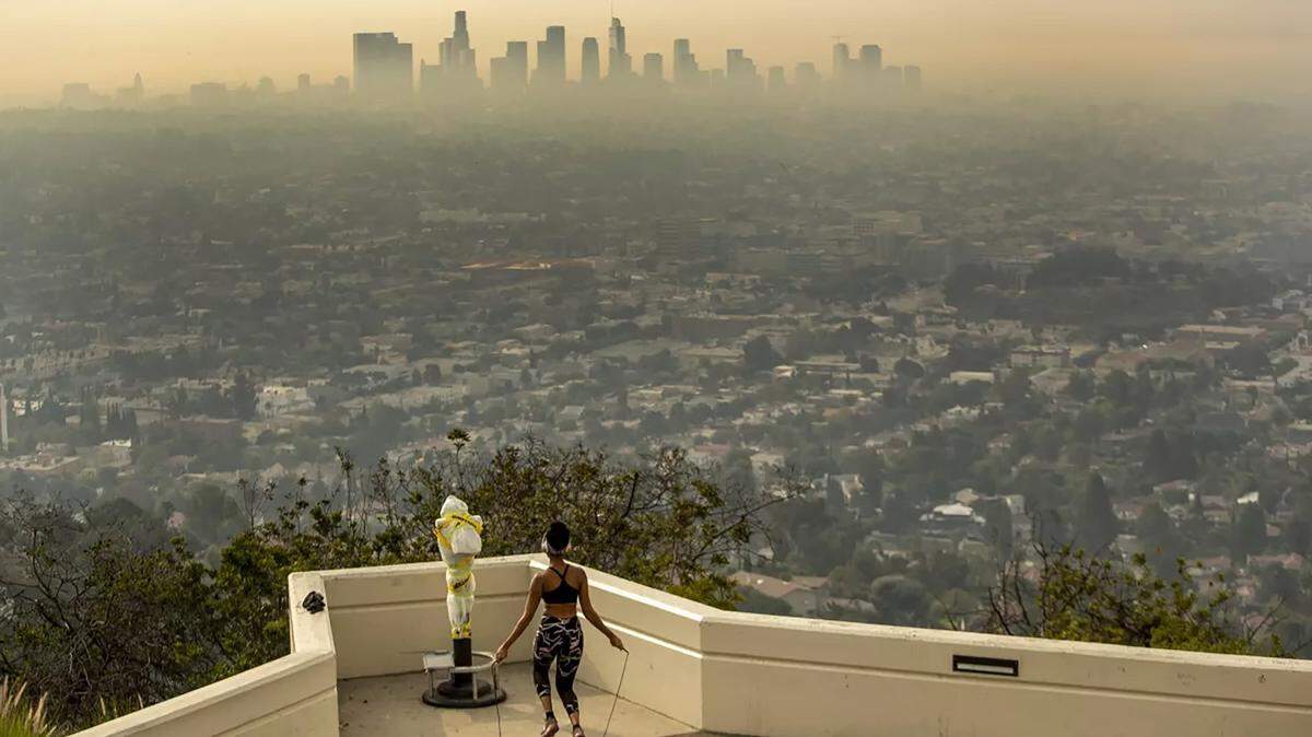 Carmen Green exercises at the Griffith Observatory, where she found a quiet nook to exercise in spite of wildfire smoke choking the L.A. Basin in September 2020.