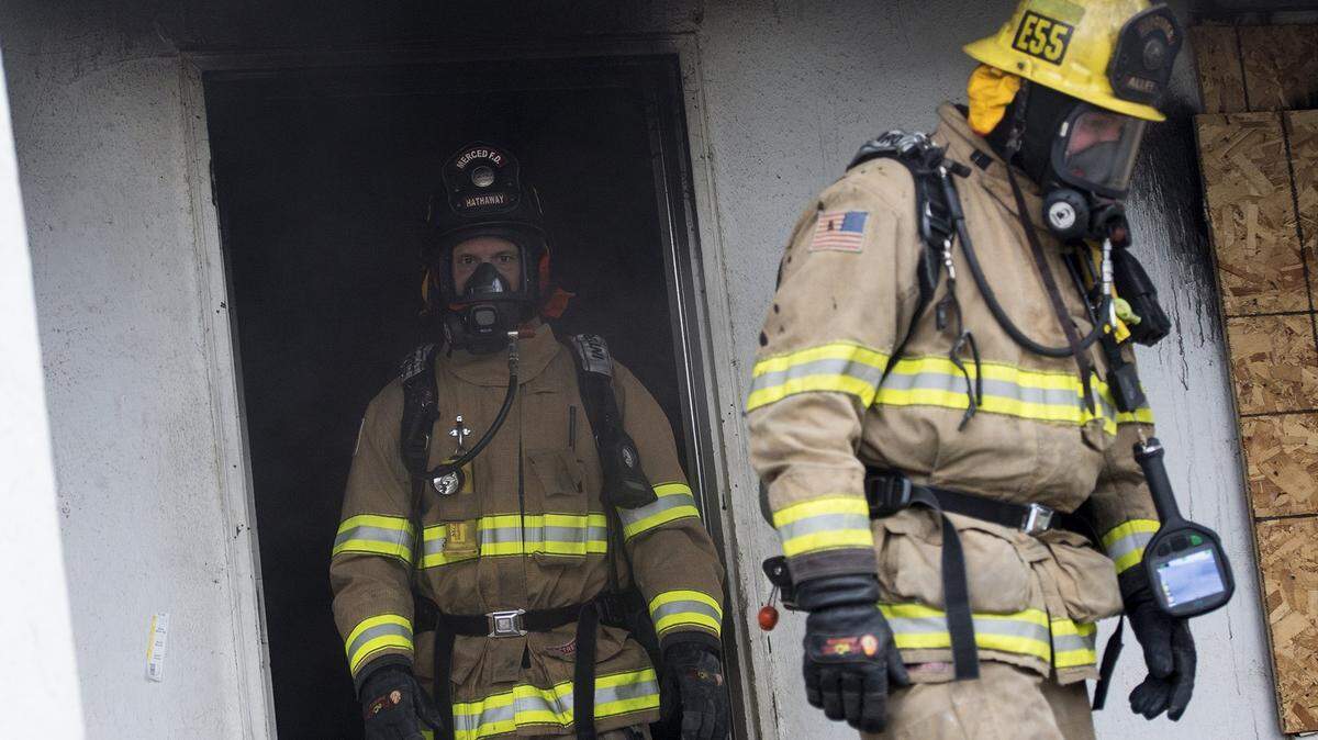 Firefighters exit an unoccupied structure during a live fire training exercise in the 1800 block of Stretch Road in Merced, Calif., on Wednesday, Jan. 9, 2019.