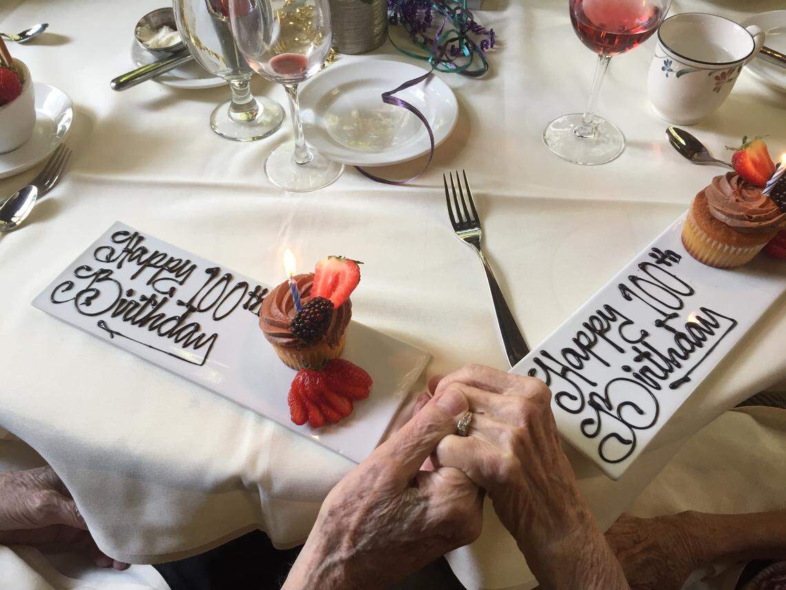 Malcolm and LaVerne Masten hold hands during a meal at The Ahwahnee Dining Room to celebrate their 100th birthdays this year. LaVerne turned 100 in October and Malcolm in August.