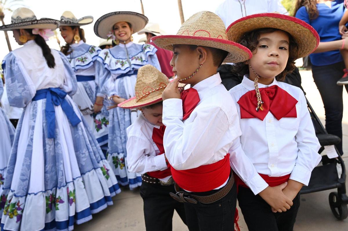 Costumed dancers await their turn to perform at the Fiestas Patrias parade and festival on Fulton Street in downtown Fresno on Saturday, Sept. 17, 2022.