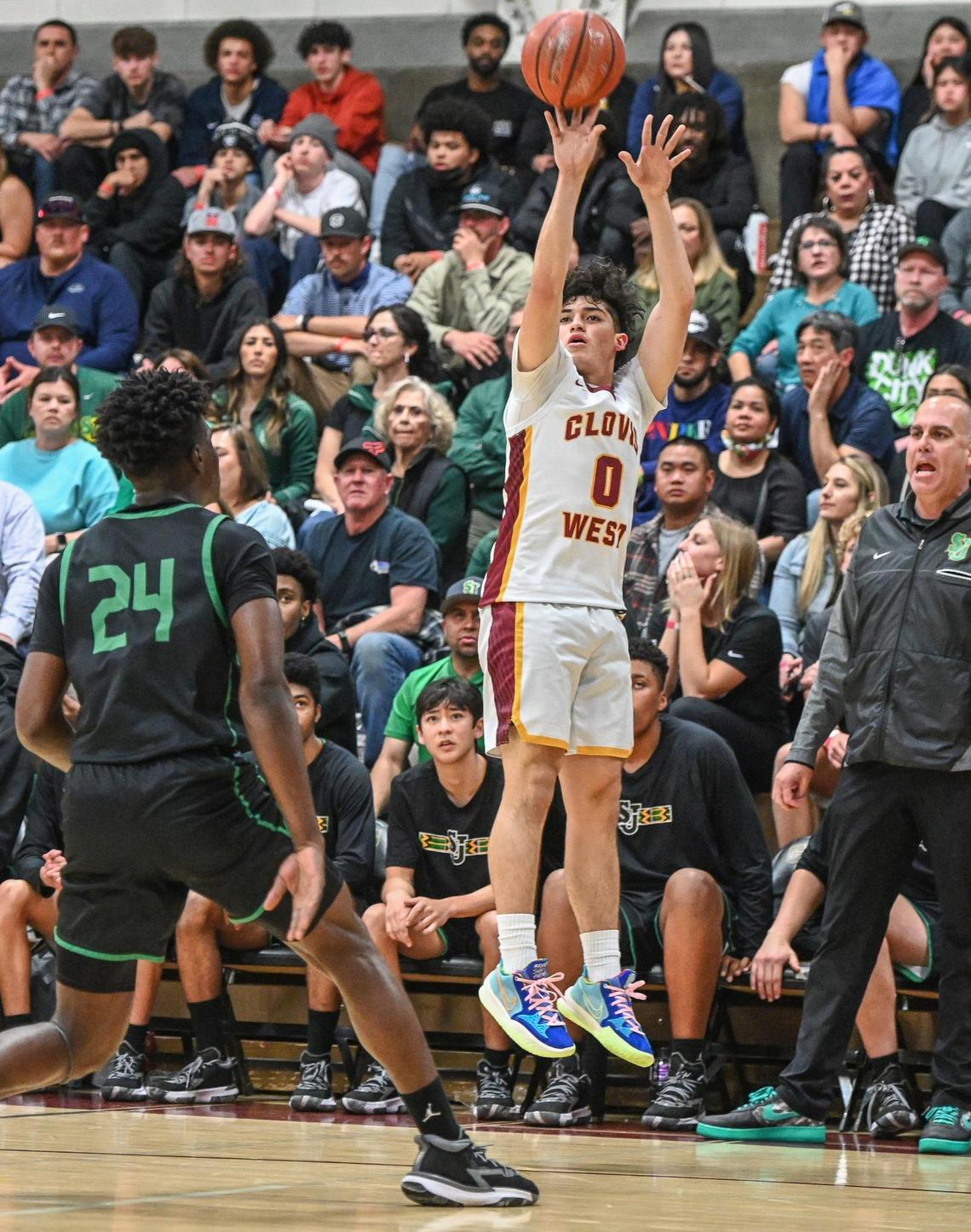 Clovis West’s Issac Martinez, right, puts up a three-point attempt while guarded by St. Joseph’s Tounde Yessoufou during their Central Section Open Division championship game at Clovis West on Saturday, Feb. 26, 2022.