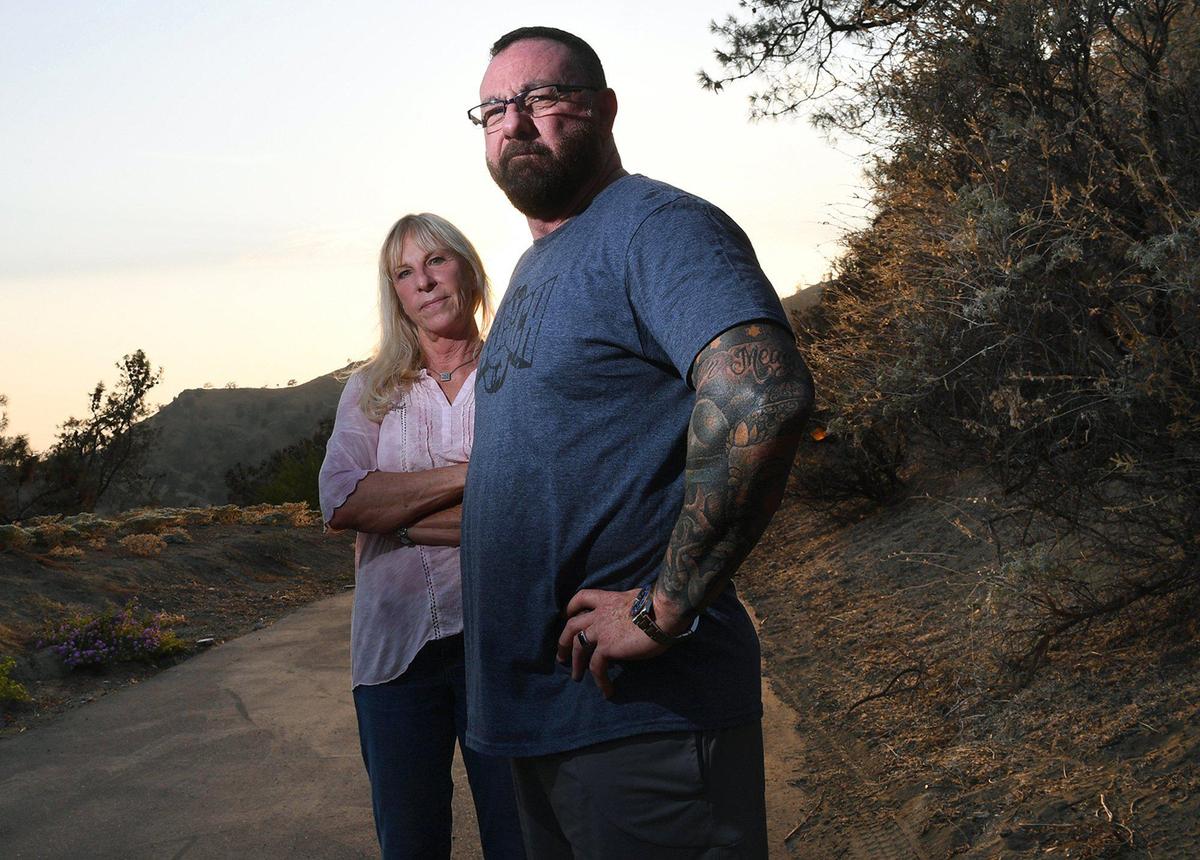 Dawn Irving, left, and David Peck, right, both live along or near Sky Harbour Road which leads to the southern portiion of Millerton Lake about a half an hour north of Fresno. Trash left by visitors has continued to be an issue for residents like Irving and Peck who would like to see access limited for non-residents at night when partiers usually visit the remote road. Photographed Thursday, July 29, 2021 near Friant.