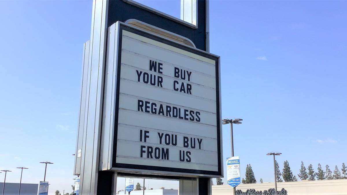 A sign at the Michael Cadillac dealership on North Blackstone Avenue in Fresno proclaims the store’s willingness to buy used cars, even if a customer doesn’t buy a replacement vehicle there. The Fresno-Visalia market had the largest year-over-year average increase in used-car prices in the U.S. between August 2020 and August 2021.