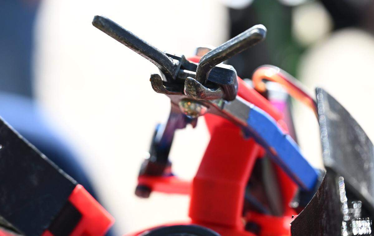A blue-handled clipper is seen connected to a robotic arm Fresno State engineering students were testing as part of the citrus harvester project Friday, Feb. 13, 2026 in Fresno.