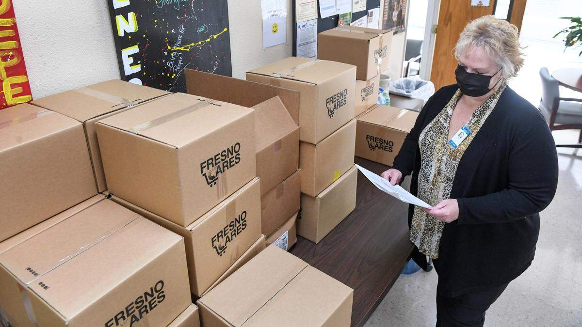 Nancy Pierce Director of Health Services at the Fresno American Indian Health Project checks on food distributions in the facility’s office in Fresno on Wednesday, March 25, 2021.