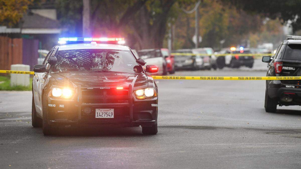 Fresno police cordon off a section of Pleasant Avenue south of Dakota in Fresno, California, after an early-morning shooting left two people dead Saturday, Nov. 20, 2021.