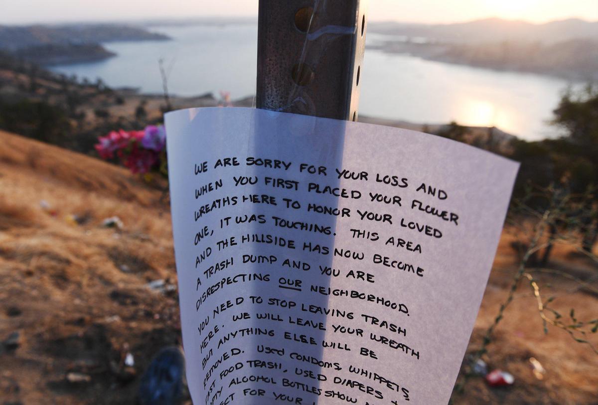 A sign left at a memorial along Sky Harbour Road empathizes with the loss of life, but demands visitors not leave trash along the road. Photographed Thursday, July 29, 2021 near Friant.