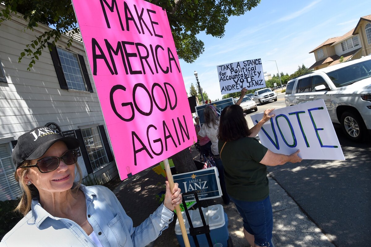 Melinda Pitarre stands with protestors outside Devin Nunes' office in Old Town Clovis, Tuesday afternoon, June 5, 2018.