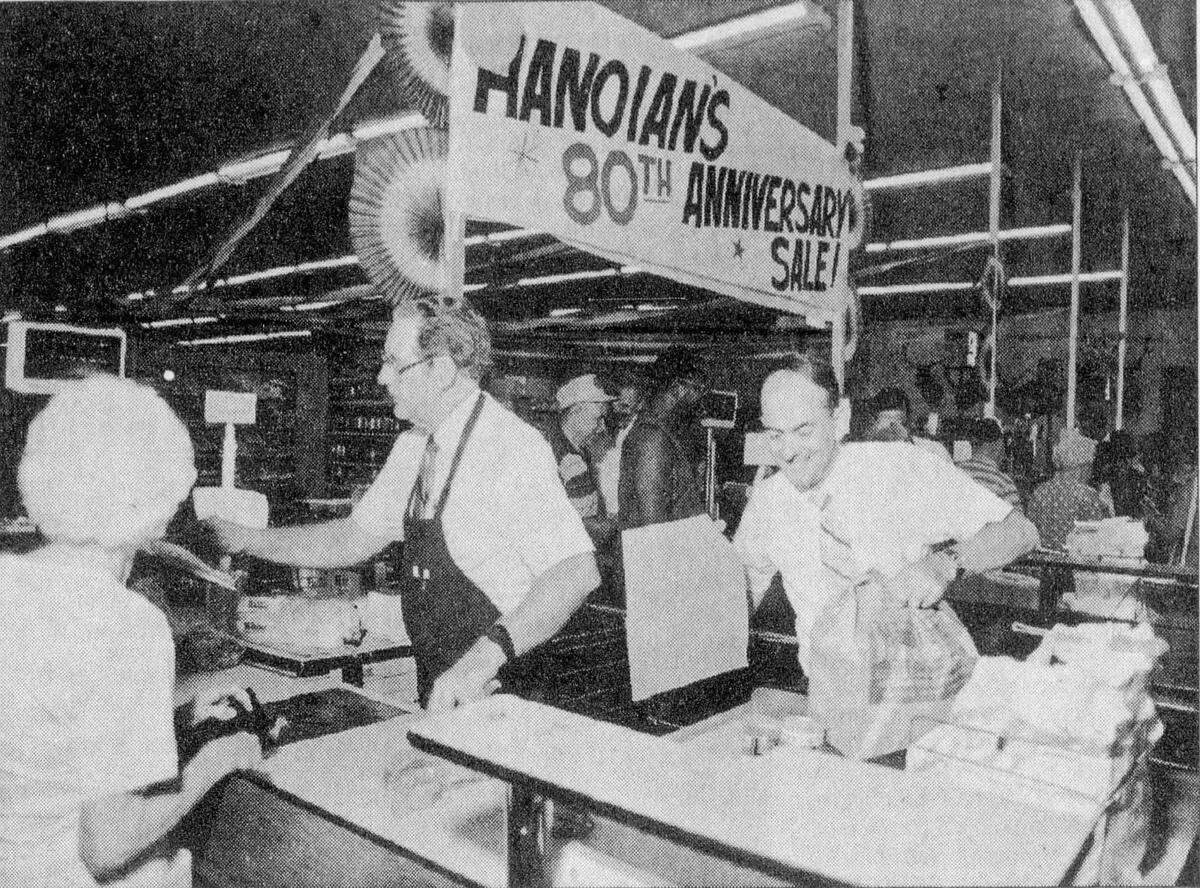 Screenshot of July 4, 1992 Fresno Bee story on the Hanoian’s Market 80th Anniversary. Verrin Dirlam, left, and Bob Hanoian help customer Elsie Schultz with her groceries.
