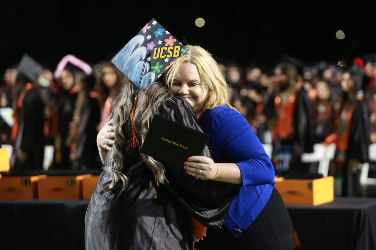 Coalinga High School principal Sheila Díaz hugs a student during the commencement ceremony at Chuck Garten Memorial Bowl on June 2.