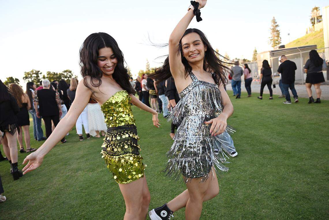 Sisters Eveleyn Navarro, left, and Patricia Navarro, both from Fresno, show off their moves as they wait in line for Colombian singer Shakira's sold out Las Mujeres Ya No Lloran World Tour show at Valley Children's Stadium, August 7, 2025 in Fresno.