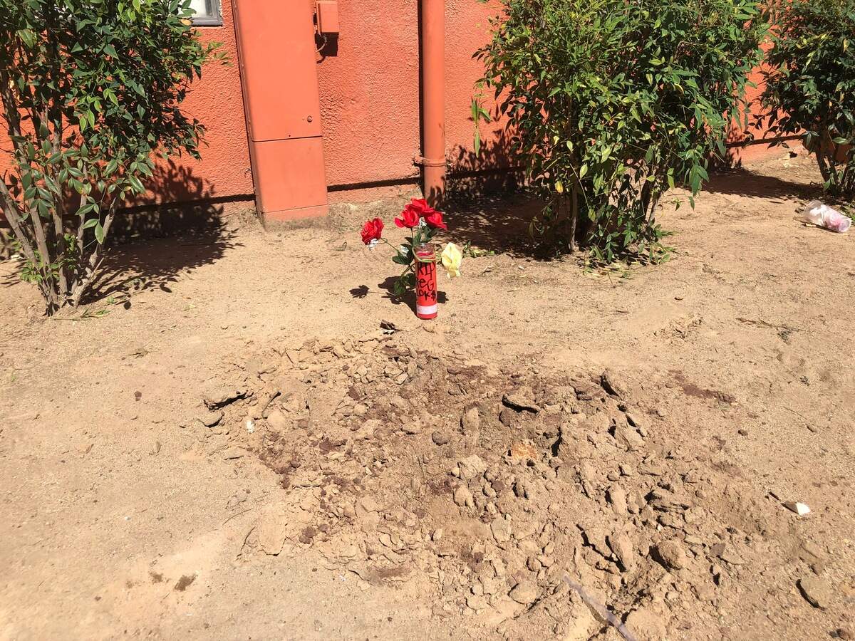 A man was shot to death outside of his apartment Friday night at the Hunter Place Apartment complex. A candle and flowers were placed in memory of the victim near the scene by residents.