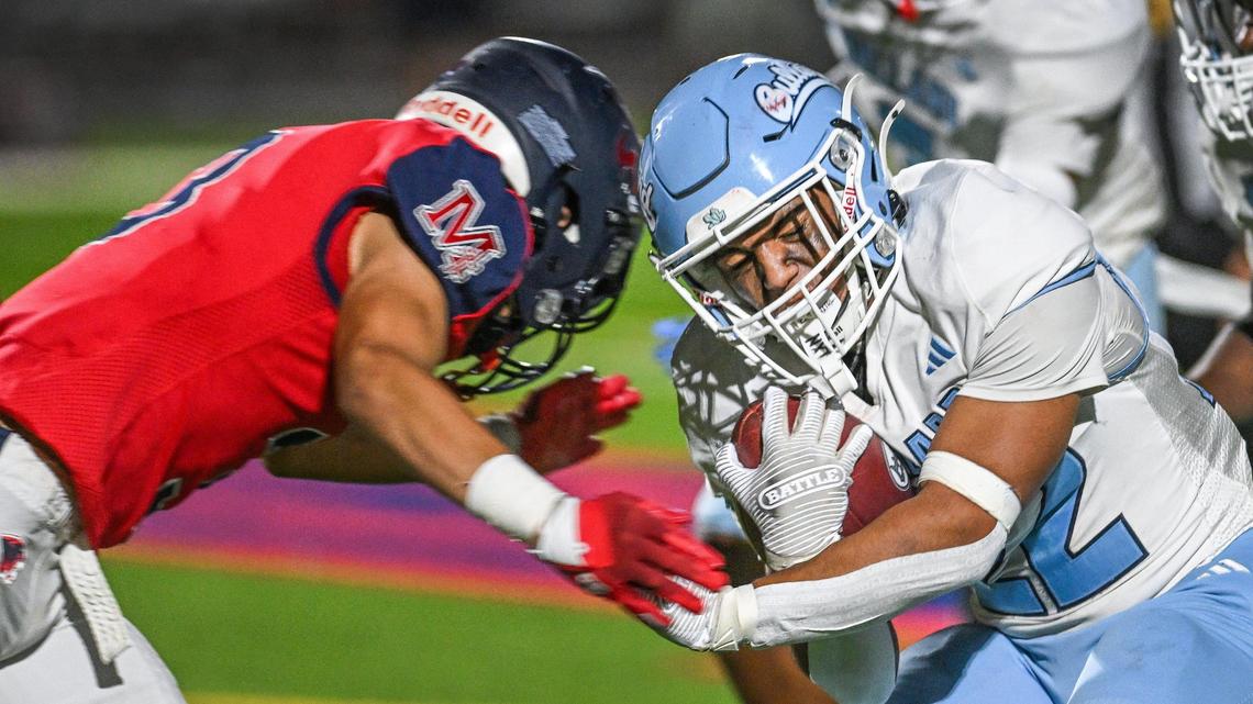 Bullard running back Devon Laney, right, slams into Memorial’s Andrew Garcia on a run up the middle in their game at San Joaquin Memorial on Friday, Oct. 25, 2024.